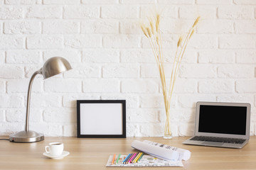 Frame and laptop on desk