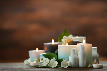 Spa composition with candles on brown background