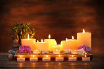 Obraz na płótnie Canvas Spa composition with candles on brown background