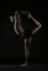 Fototapeta na wymiar man practicing yoga, studio photo