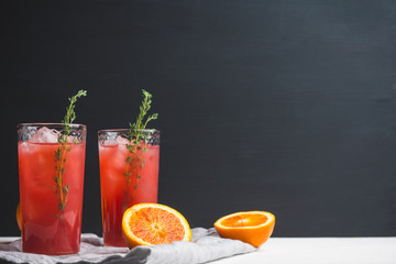 Cocktail made of Sicilian orange on the rustic wooden background