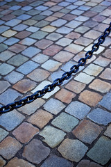 Metal chain an cobblestone