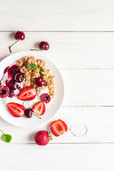 healthy breakfast with yogurt, muesli and berries, top view, flat lay