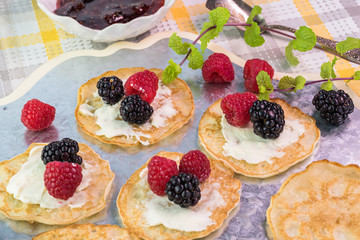 Cornmeal cakes garnish with fresh berries and bowl of berry fig