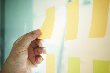 Note paper reminder schedule board. Business people meeting and use post it notes to share idea....