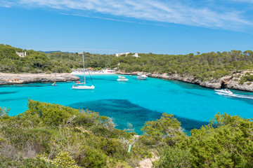 Fototapeta na wymiar Sailing boats at Cala Mondrago - beautiful beach and coast of Mallorca