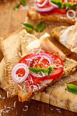 Sandwich with ham, tomato, cheese and fresh oregano