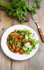 Bean stew with fresh parsley, salad, cucumber, radish and tomato