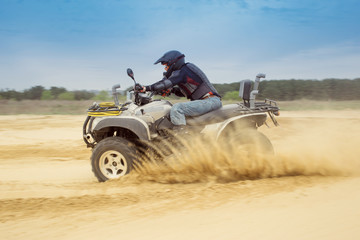 Racing ATV is sand.