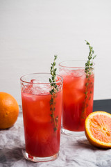 Cocktail made of Sicilian orange on the rustic wooden background. Shallow depth of field.