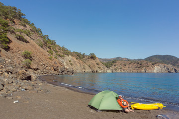 Men travel by canoe on the sea in the summer.