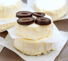 pieces of goat cheese with olives