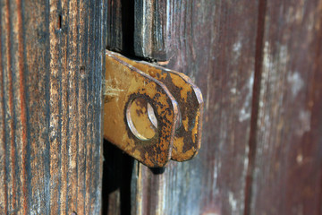 two old rusty metal steel eyelets for padlock on wooden door clo
