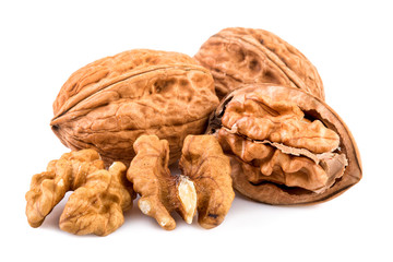 Walnuts and shelled walnuts on white background. Closeup.