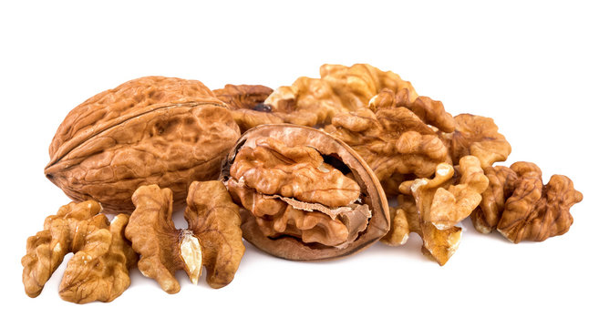 Walnuts and shelled walnuts on white background. Closeup.