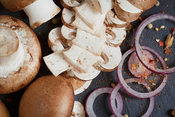 Button mushroom with rosemary, onion and peppercorns. Still life