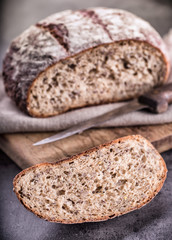 Bread. Fresh bread. Homemade traditional bread. Sliced bread crumbs knife and cumin.