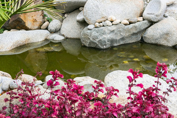 Beautiful Garden Design With Stones And Lake.