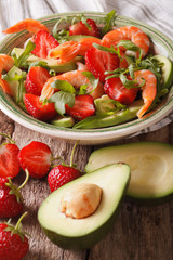 Cocktail salad with strawberries, avocado, shrimp and arugula. Vertical
