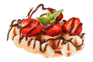 Belgian waffles with strawberries and chocolate close up isolated on white 
