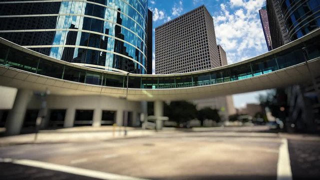 Modern office buildings in downtown Houston, Texas as traffic passes by, timelapse (Cars, people and logos blurred for commercial use)