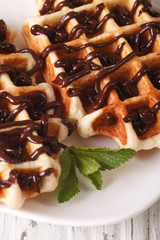 Belgian waffles topped with chocolate macro on a plate. Vertical
