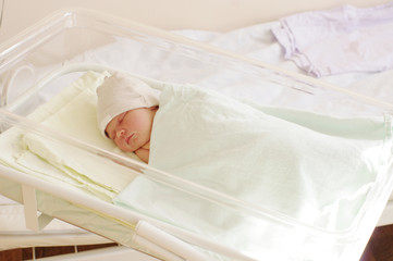Fototapeta na wymiar Lovely newborn baby girl in maternity hospital. 4 days