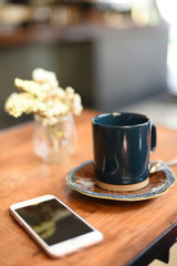 cup of coffee latte art on the wooden desk