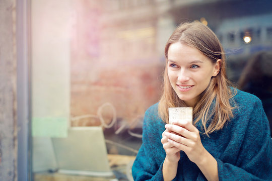 Smiling woman drinking a glass of milk