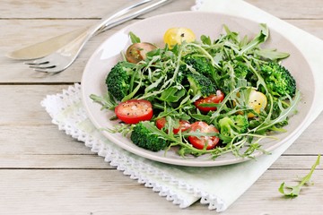 Broccoli salad with tomatoes and arugula .Selective focus 