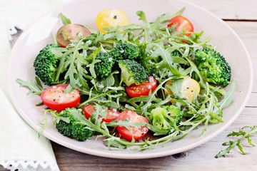 Broccoli salad with tomatoes and arugula .Selective focus 