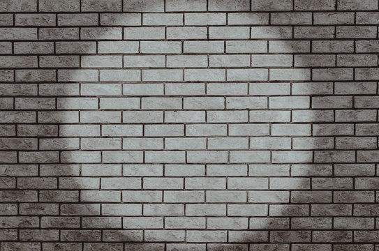 Spotlight on brick wall
