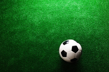 Soccer ball against artificial turf. Studio shot. Copy space.