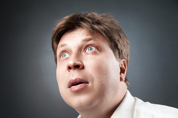 Fototapeta premium Close-up of adult man looking up in amazement