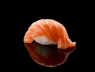 Salmon sushi nigiri over black background