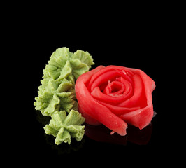 Ginger and wasabi over black background