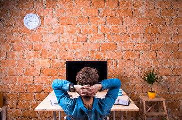 Business person sitting at office desk wearing smart watch