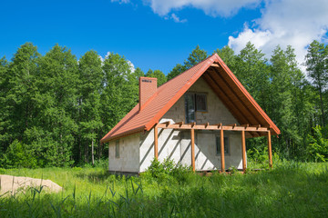 Construction site of white, little house.