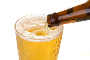 Pouring an Ice Cold Beer &ndash; Beer pours into a cold glass from a beer bottle.