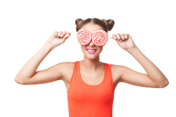 Portrait of woman with buns holding lollipops on eyes