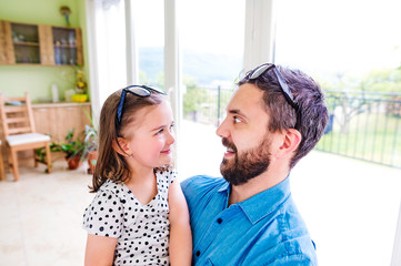 Father with his little daughter making funny face