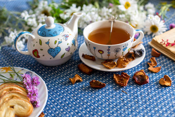 cup of tea with book and flower