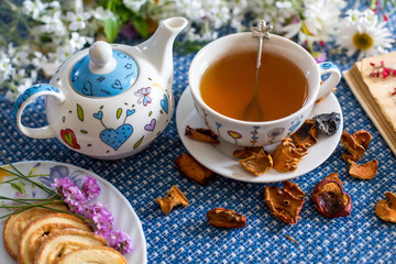 cup of tea with book and flower