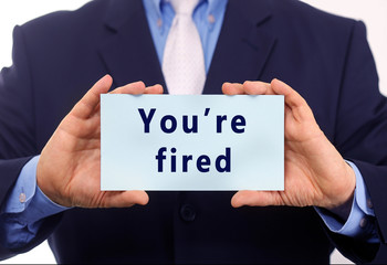 Obraz premium Business man hold paper you're fired text on it