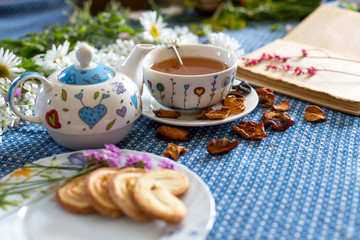 cup of tea with book and flower