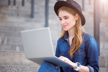 Modern young woman using technologies