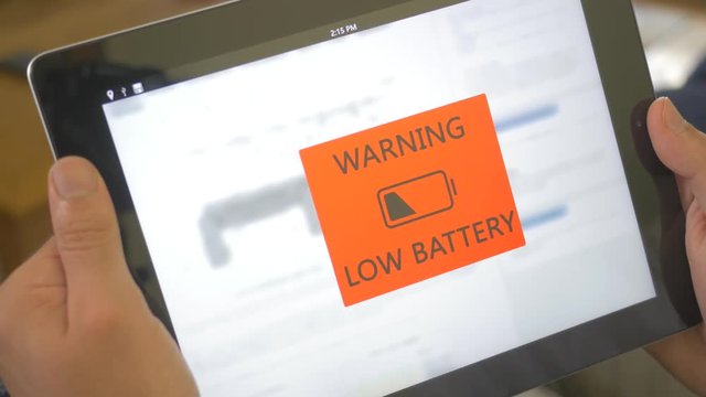 Battery warning showing low energy power on iPad tablet screen.