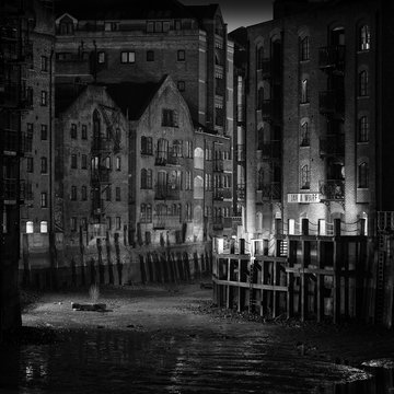 B&W Photo of a Dickensian Wharf with Victorian Warehouses at night