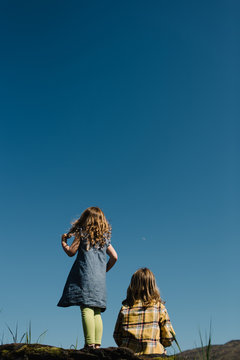 Sisters looking at blue sky