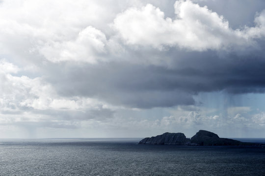 Clouds over rocks in ocean